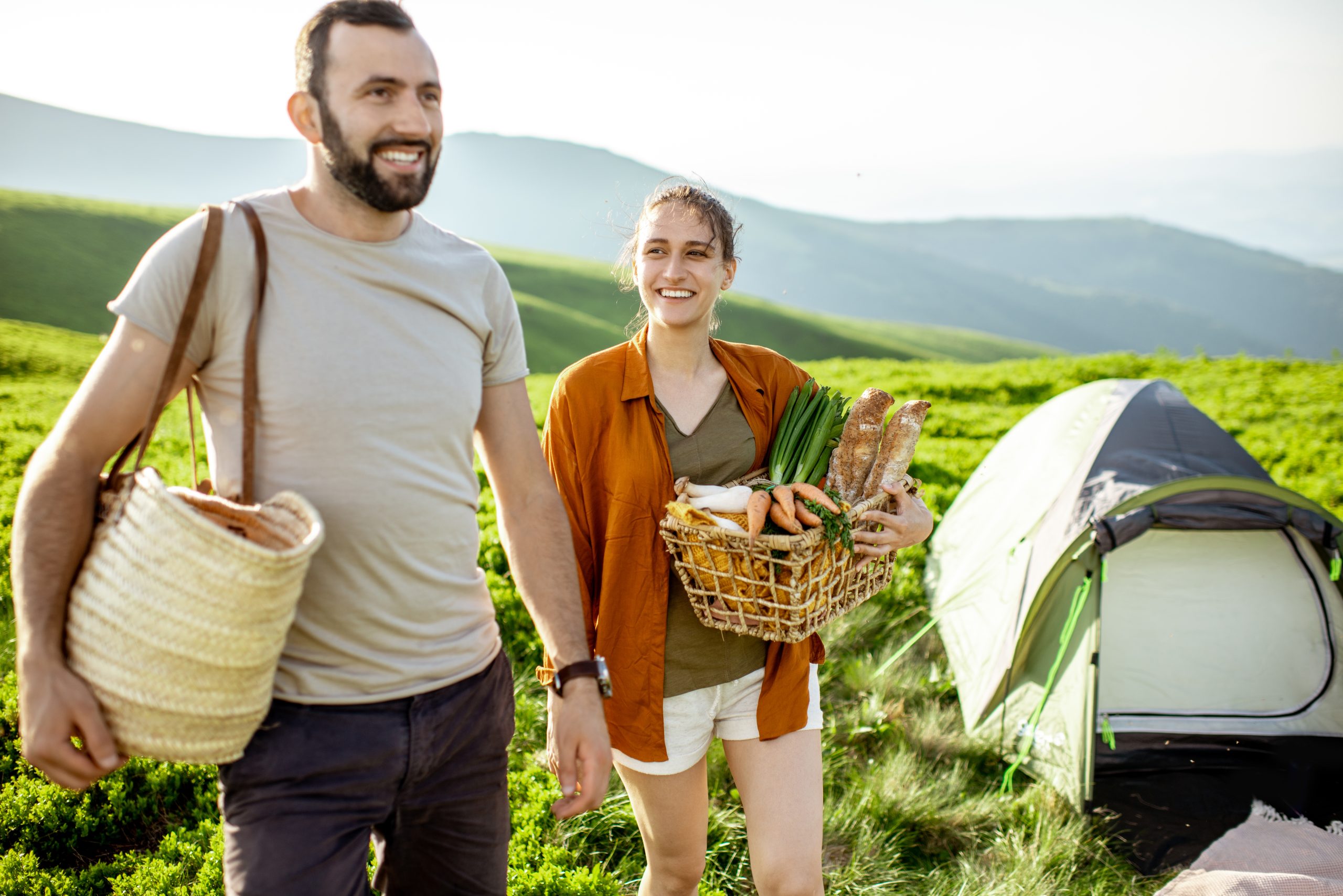 Couple hiking with food in rural landscape