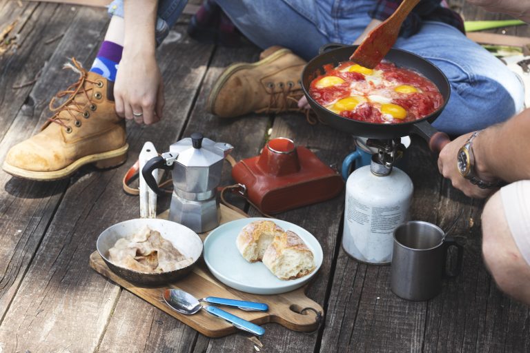 Girl preparing breakfast on the pier