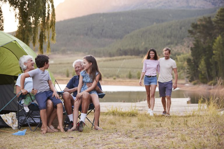 Multi generation family on camping trip by lake to