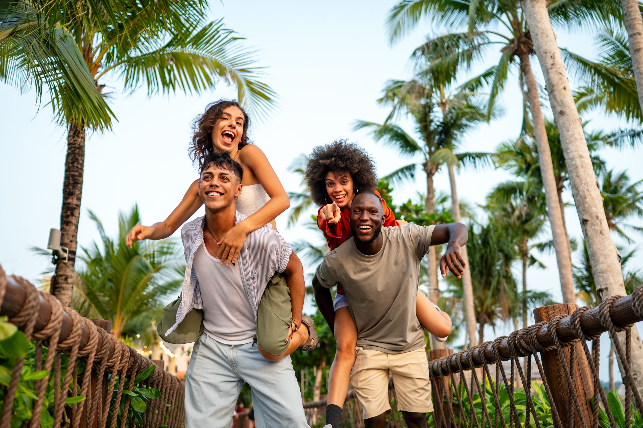 Two young couples having fun giving piggyback ride